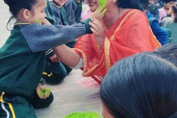 "Breaking the barriers of age and hierarchy, teachers and kids immerse themselves in the festive spirit by playing Holi together in the school campus."